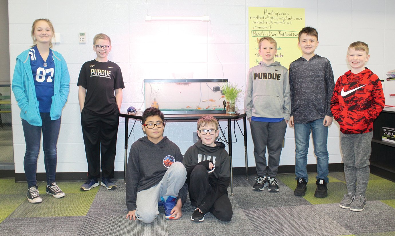 Ladoga Elementary students who have been part of the recent hydroponics project show off their work with the self-contained ecosystem Thursday during school. They include fourth graders Peyton Cornell, from left, Tyler Thompson, Keanu McQueen, Landon Dagley, Trent Reeves, Landon Grimes and Cooper Scott.